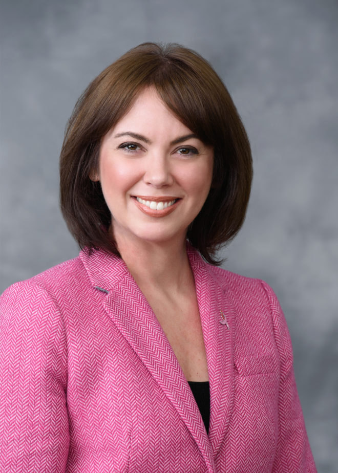Gretchen Awad - a young woman with medium length brown hair, smiling and wearing a pink blazer.