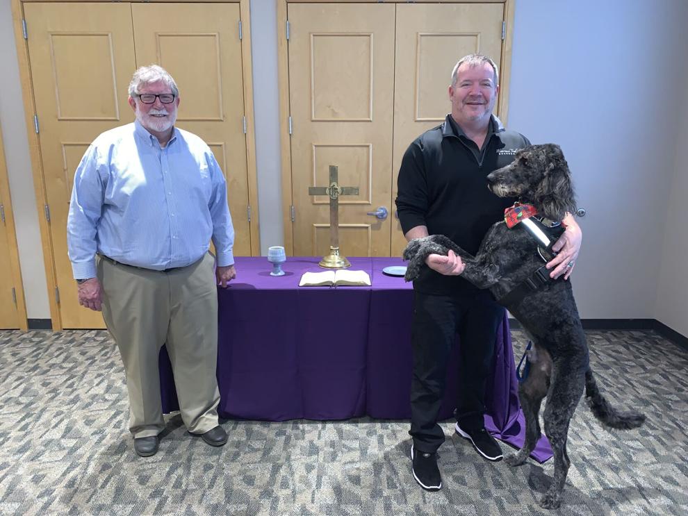 Shown at the Serrick Center on the campus of Defiance College where the services are held are Dr. Fred Coulter (left), and Pastor Dave Brobston with his service dog, Guinness.