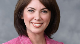 Gretchen Awad - a young woman with medium length brown hair, smiling and wearing a pink blazer.