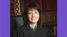 Ohio Supreme Court Justice French: woman with medium-length brown hair smiling at the camera and wearing black robes.