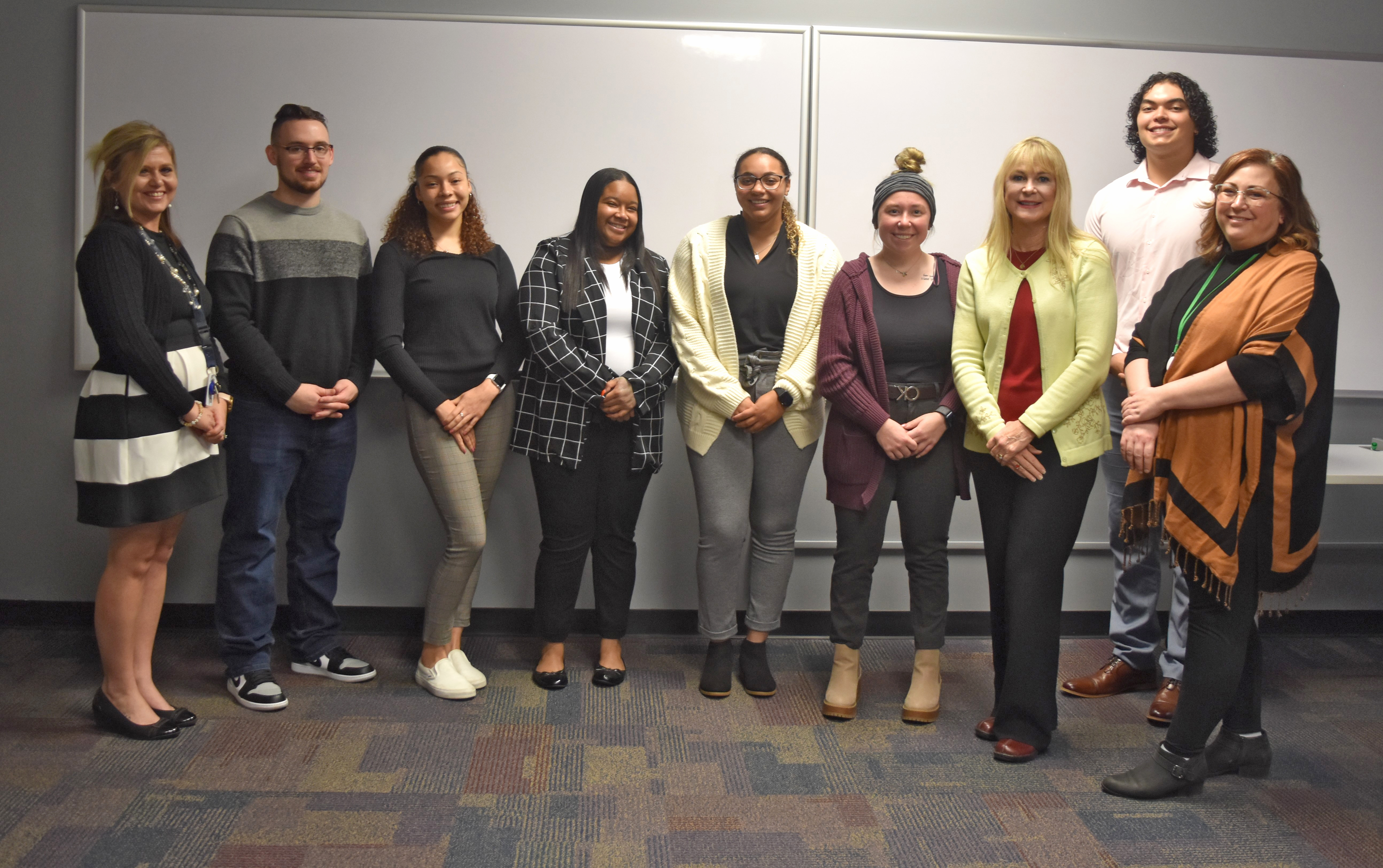 Pictured (L-R): Kalea Scott, NOCAC Financial Empowerment Facilitator, Joseph Spradlin, Mikeaya McLaurin, Kimmel Brown, Marissa Roberts, Abbe Rank, Professor Yakos-Brown,  Tyrel Goings, and Jamie Huber, NOCAC Community Services Director. Not pictured: Max Julien, Sydney Hoiberg, and Te'Von Carson-Payton.