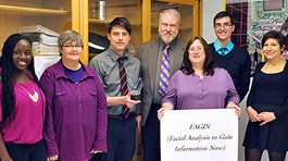 Six D C students and Professor Wedge with white sign reading F A G I N