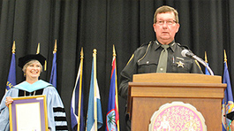 President Richanne Mankey and Sheriff Dave Westrick on stage