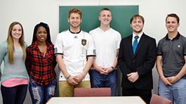 six students in front of chalkboard