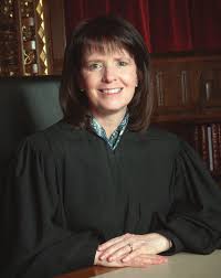 Ohio Supreme Court Justice French: woman with medium-length brown hair smiling at the camera and wearing black robes.