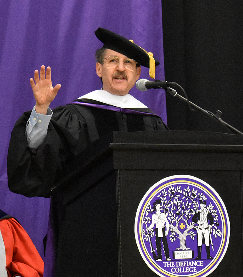 Howard Reich speaking at a Defiance College podium