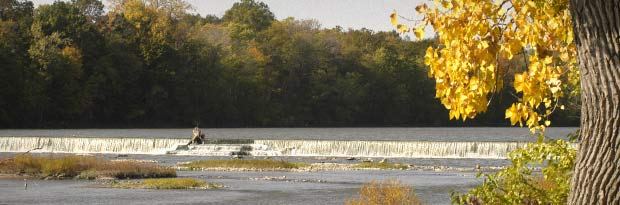 a summer time picture of water spilling over the Indepence State Dam