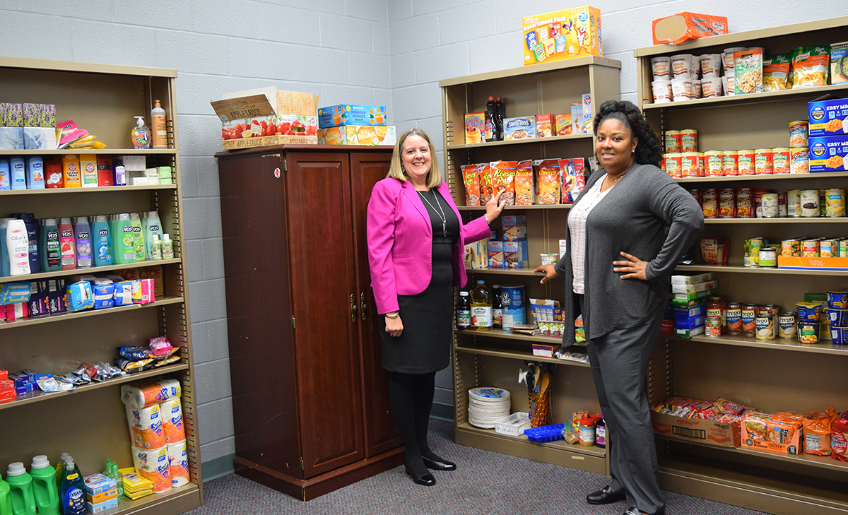 Lisa Marsalek and Mercedes Clay in the Jacket Care corner with shelves of supplies
