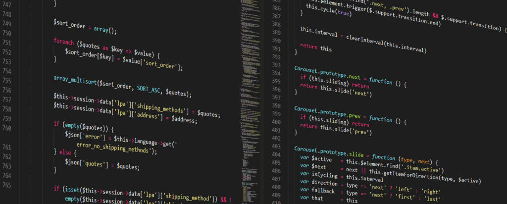Close-up of a computer screen displaying colorful lines of PHP and JavaScript code on a dark background. The code is divided into two columns, with syntax highlighted in various colors.
